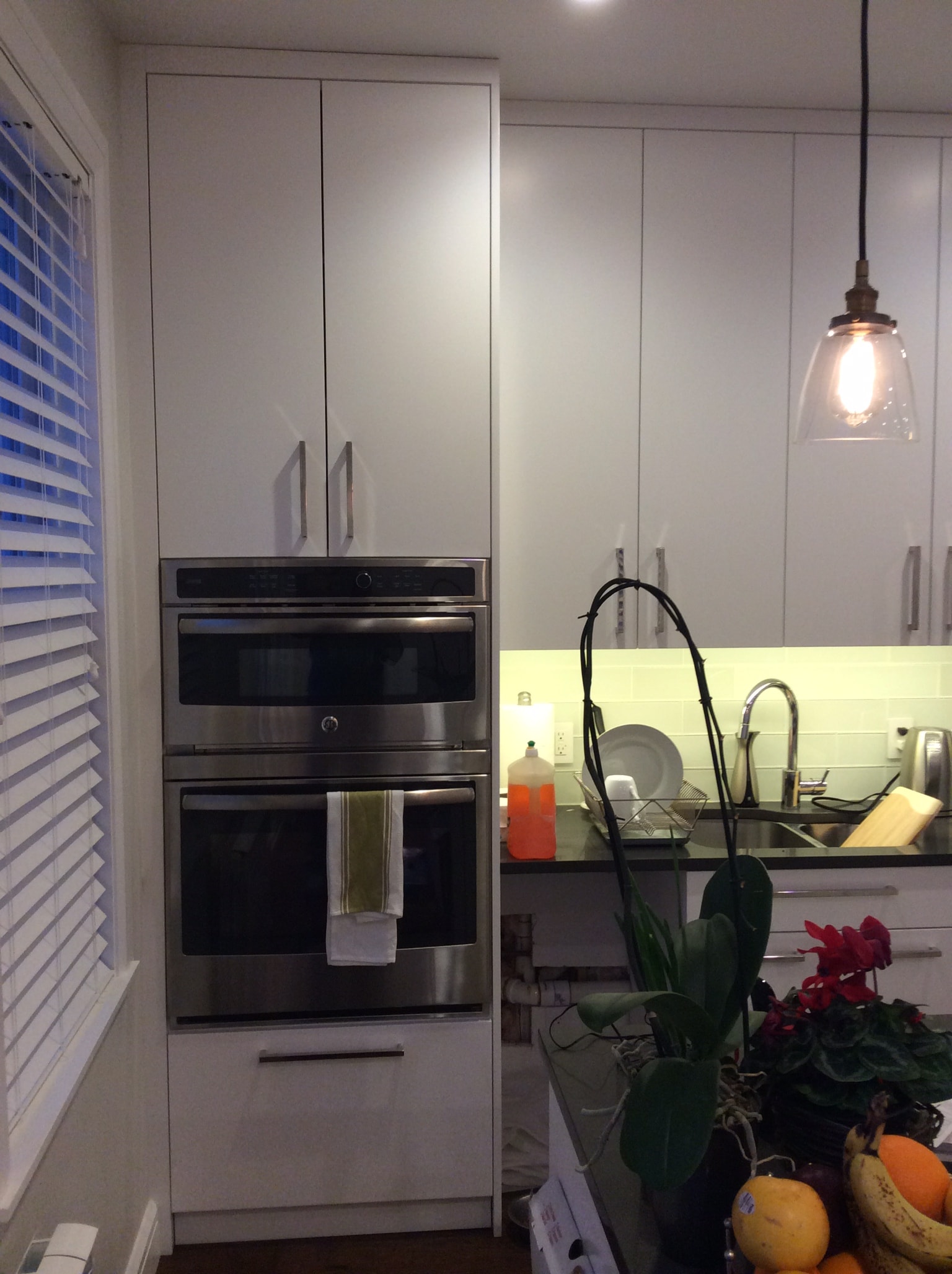 Modern kitchen with white cabinets and stainless appliances