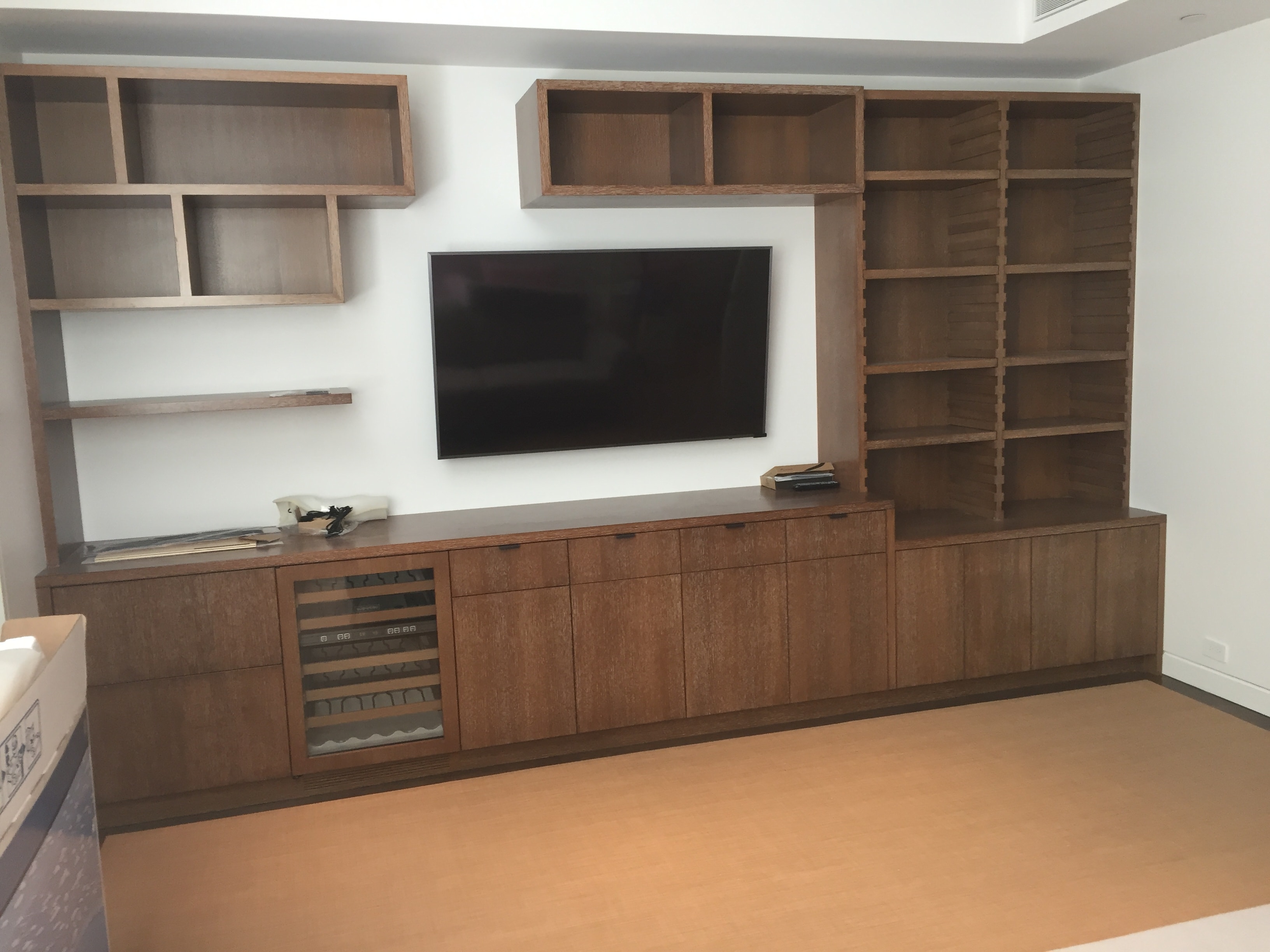 Wooden entertainment center with wall shelving